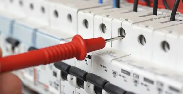 Electrical contractor testing circuit breakers during electrical repair in New Lebanon, OH