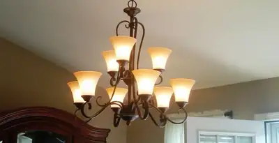 Classic ceiling chandelier installation with warm lighting in Dayton, OH
