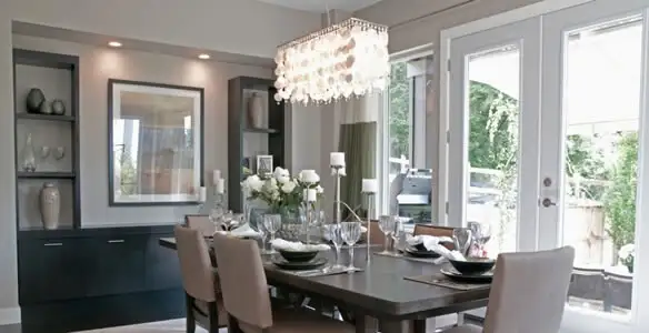 Elegant dining room chandelier installation above table in Dayton, OH