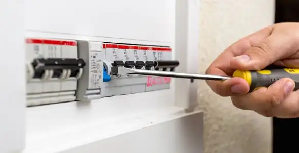 electrical panel upgrade service showing technician adjusting circuit breakers during system upgrade in Dayton, OH