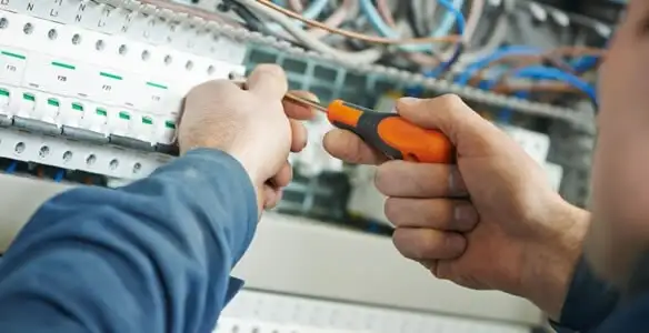 electrical service showing licensed electrician performing electrical panel maintenance and adjustments in Dayton, OH
