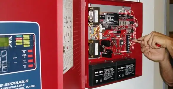 fire alarm installation service showing technician configuring fire alarm control panel in Dayton, OH