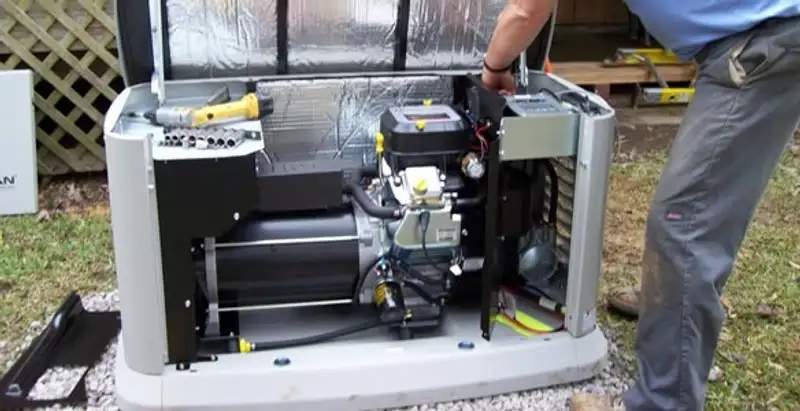 generator installation service showing technician connecting and configuring generator components in Dayton, OH