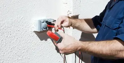 Electrician performing home electrical outlet and wiring inspection in Dayton, OH