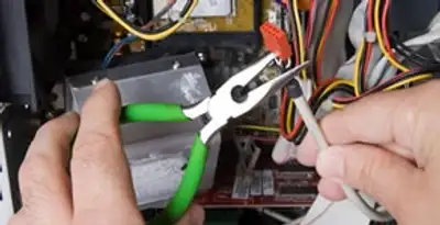 Licensed electrical contractor performing electrical repair with tools in New Lebanon, OH