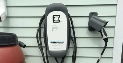 Outdoor electric vehicle charger installation on residential wall in Dayton, OH