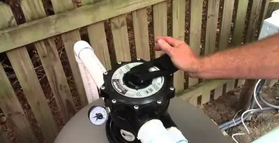 pool pumps service showing professional adjustment of pool pump control system in Dayton, OH