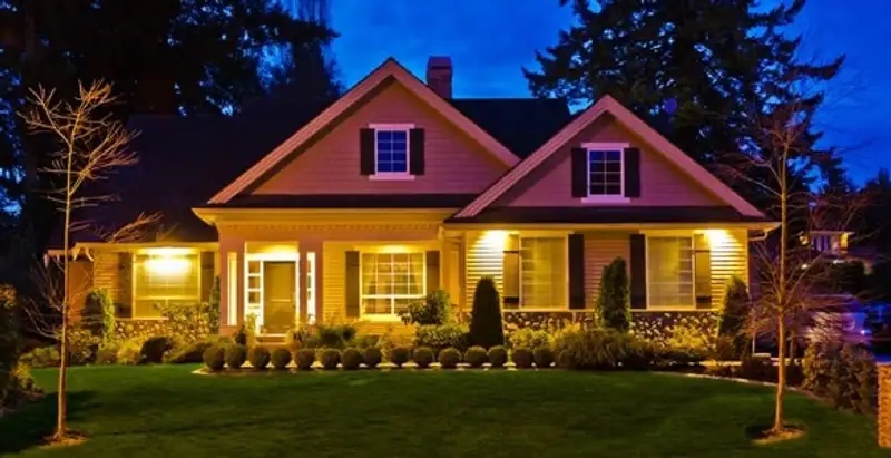 security light installation services illuminating a residential exterior at night in Dayton, OH